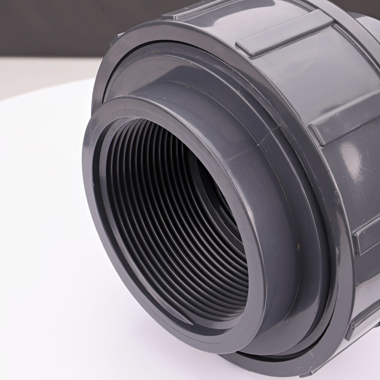 Closeup view of one threaded end on the NDS 3 in. PVC Union (NDS U-3000-T) which provides a corrosion-free connection between pipes and prevents costly property damage