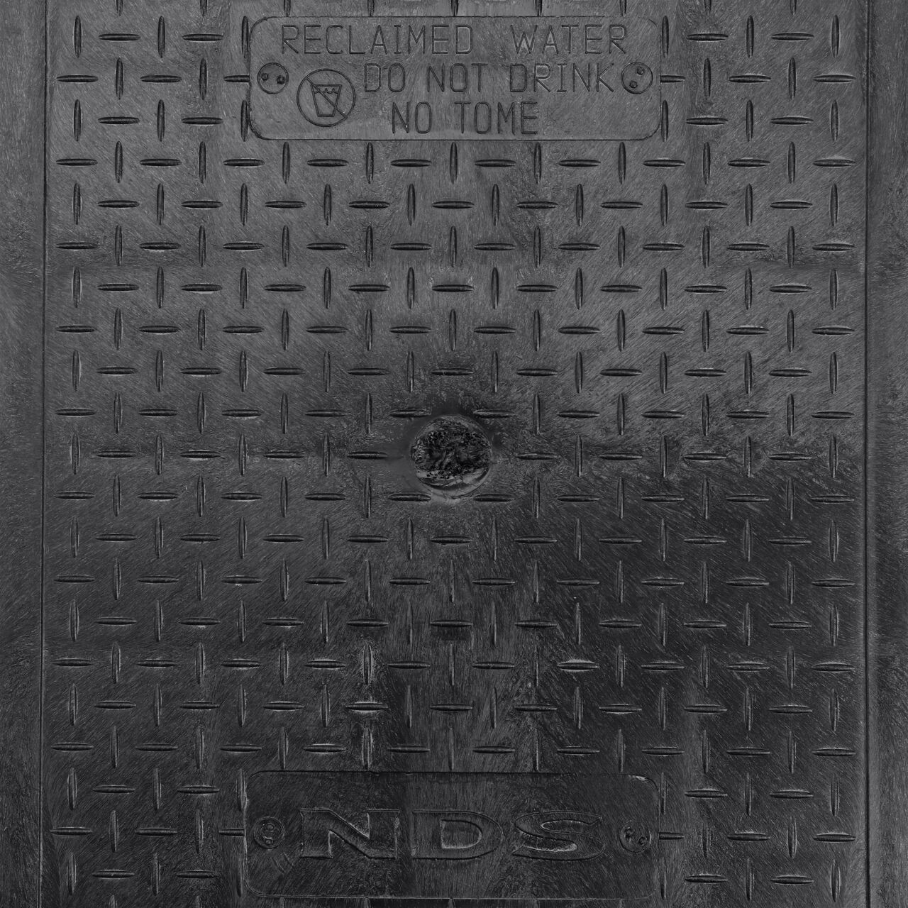 Closeup view of the reclaimed water markings on the black reclaimed water cover (NDS 313CRBLK) for the NDS 14 in. X 19 in. Rectangular Pro-Spec® Series Valve Box