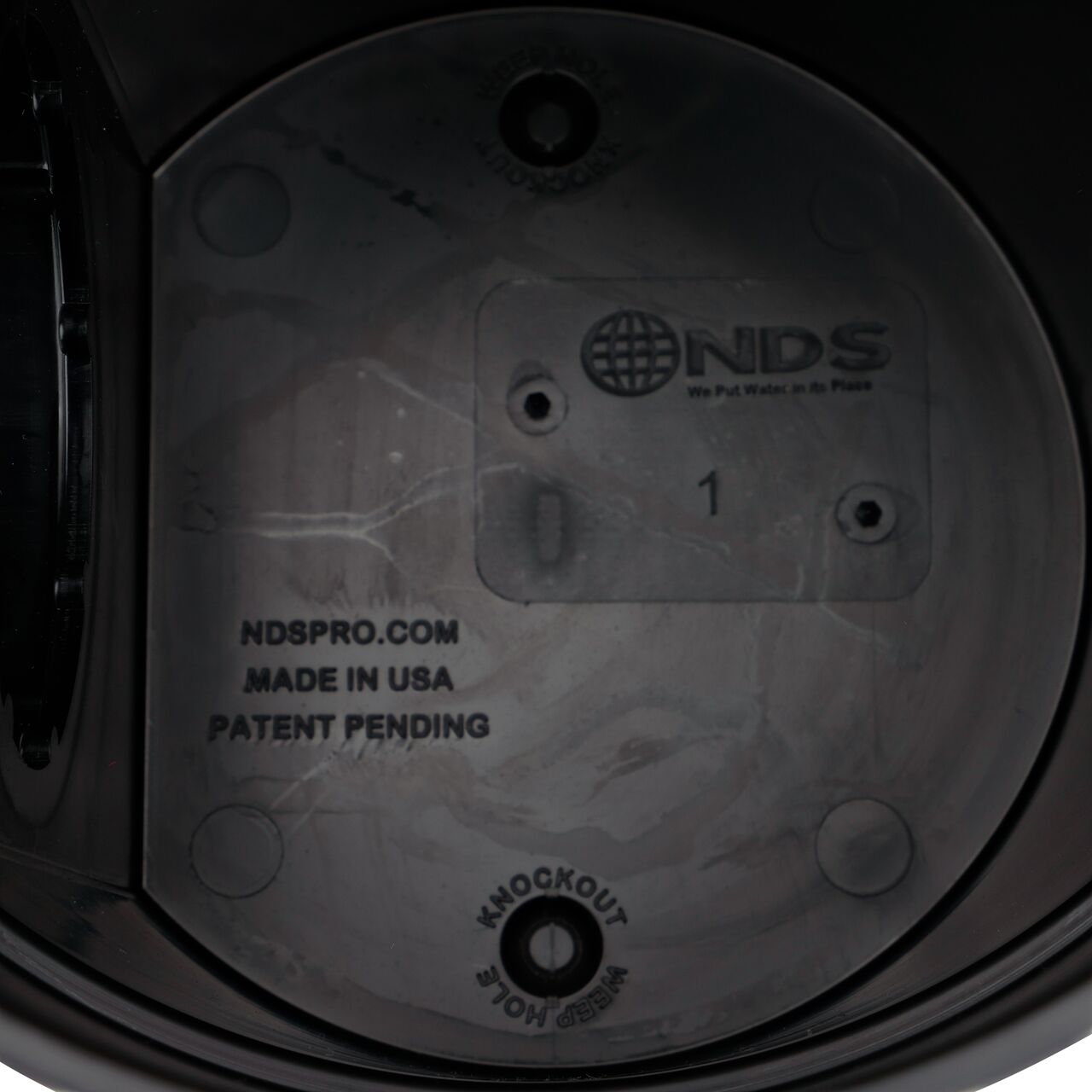Inside view of the 6 in. Round Spee-D® Catch Basin Drain (NDS 101) with knockout weep holes in the bottom