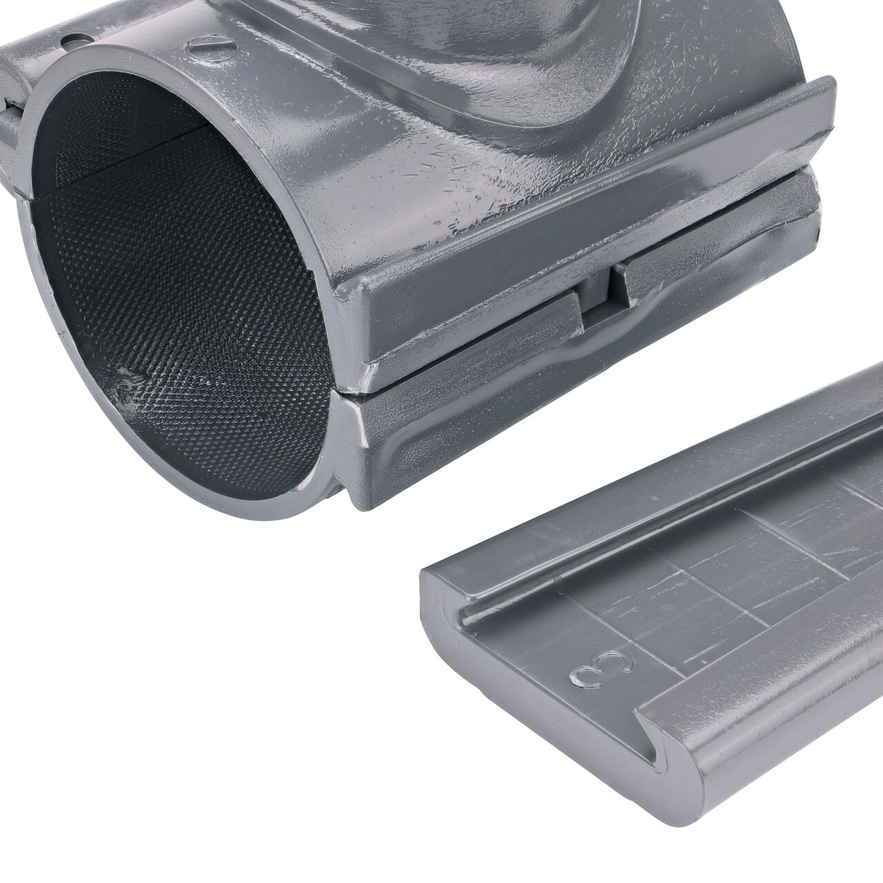 Closeup of the wedge latch uninstalled on the NDS Clamp-It™ Rigid PVC Saddle with 1-1/2 in. FPT connection on top (NDS 443015) for 3 in. PVC pipe