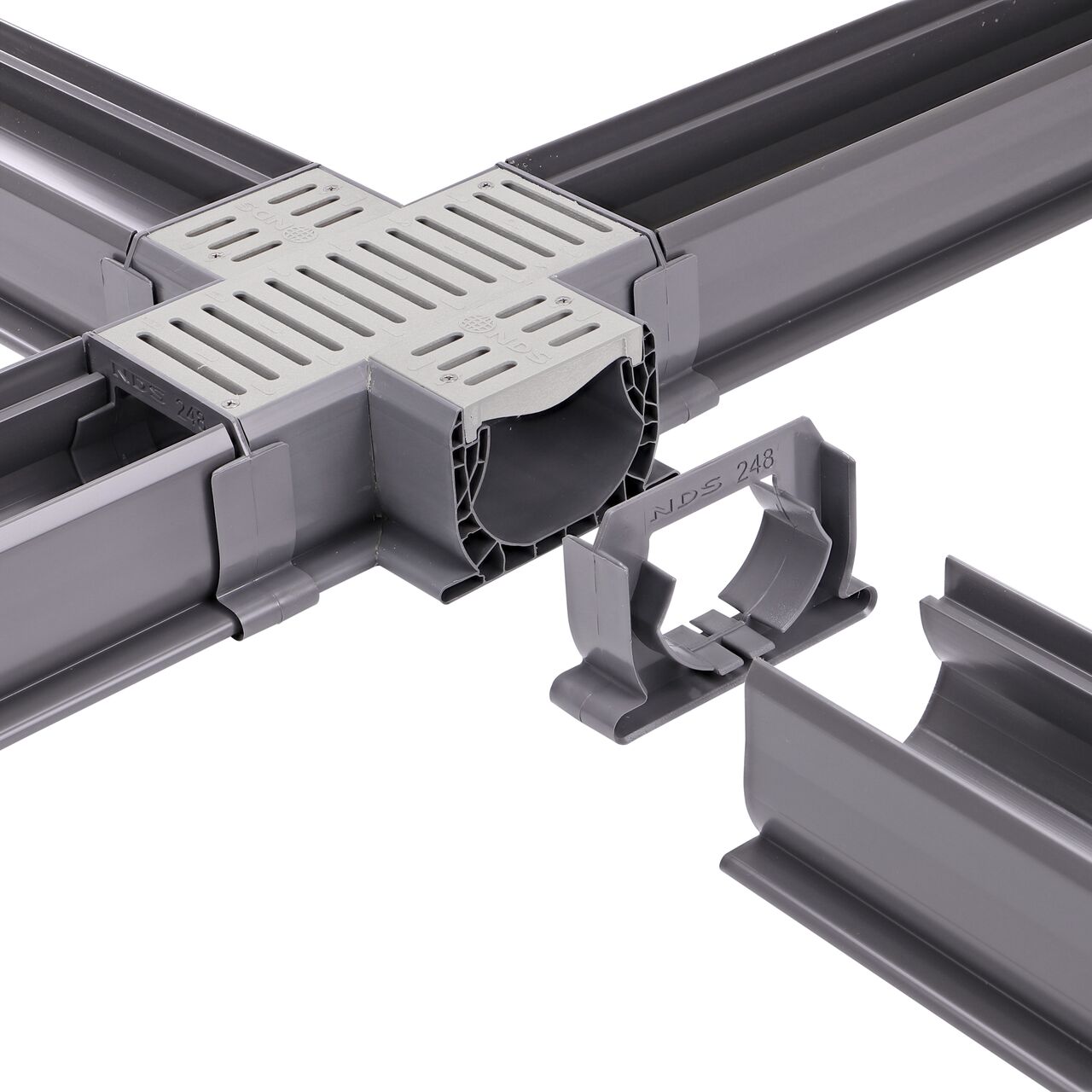 Fully installed NDS Gray Spee-D® Channel Drain Cross and Grate (NDS 2361) with couplers attached to all ends with channel drains connected