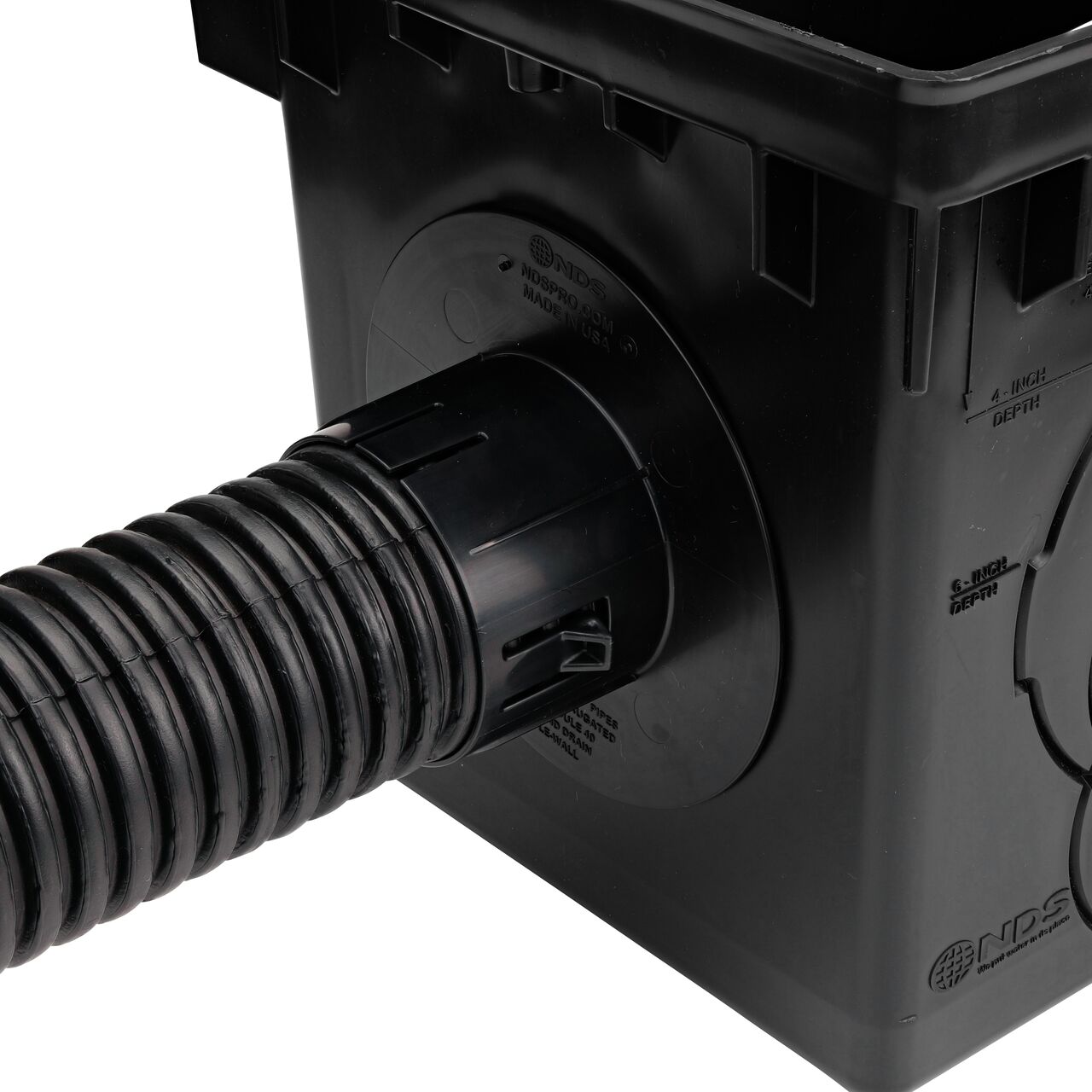 Connect 3 in. corrugated pipe in the locking tab outlet adapter (NDS 1243) on the 12 in. Catch Basin Drain (NDS 1200)