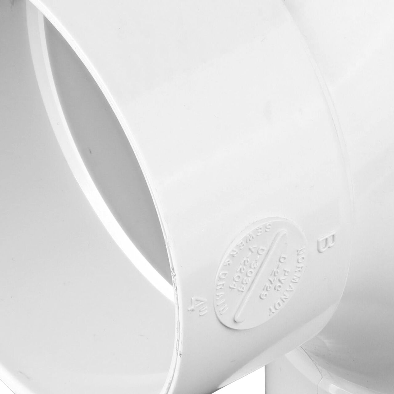 Closeup of the outside part of the  4 in. PVC Double Cleanout which has three S&D Hub connection points (NDS 417P)
