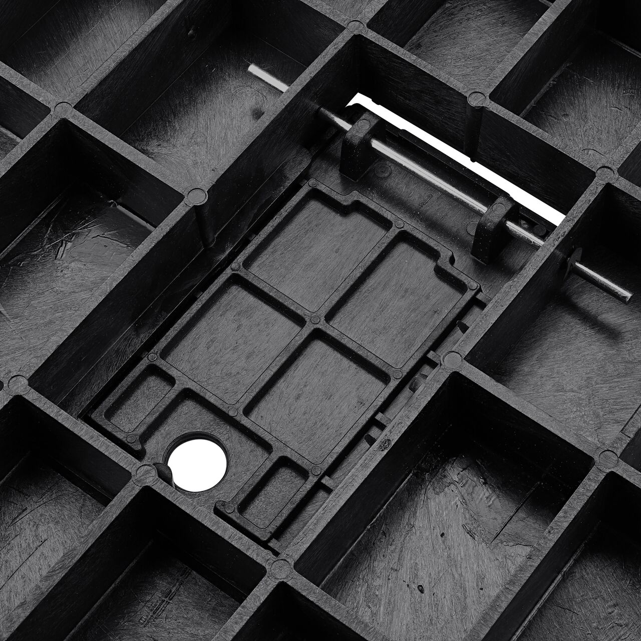 Close up view of the underside on the Black Water Meter Drop-in 13 in. X 20 in. Rectangular Standard Series Meter Cover showing the hinge of the Plastic reader door on the (NDS D1500-DIRBL)