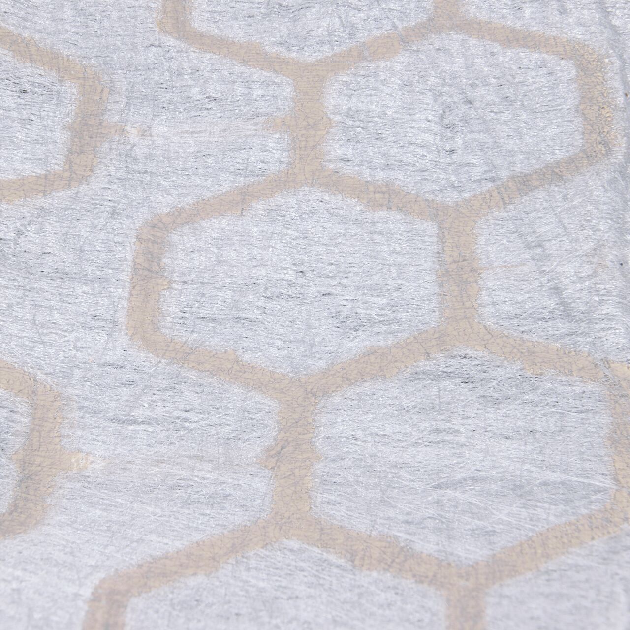 Closeup View of thermally welded, puncture-resistant geotextile fabric on the tan NDS EZ Roll® Gravel Pavers (NDS GP4X150T); fabric prevents gravel from migrating downward and lifting the paver, and is also porous to allow for filtration of stormwater runoff