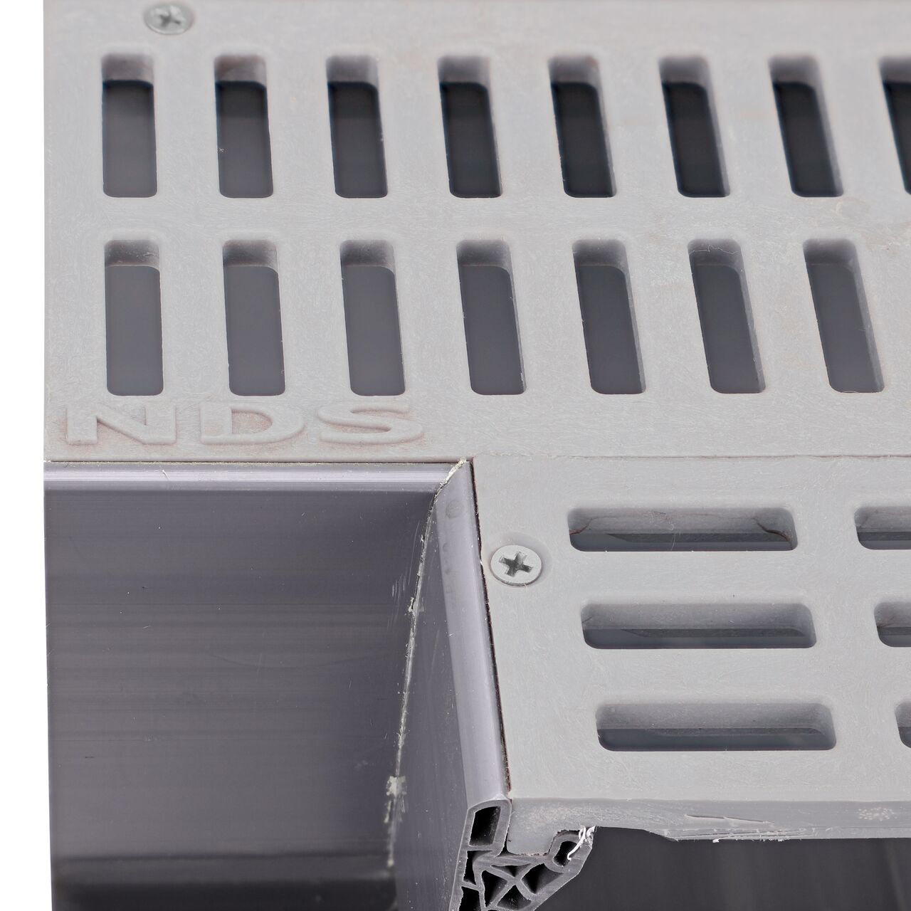 Closeup of any branding of the NDS Gray Mini Channel™ Drain Tee and Grate (NDS 5370)