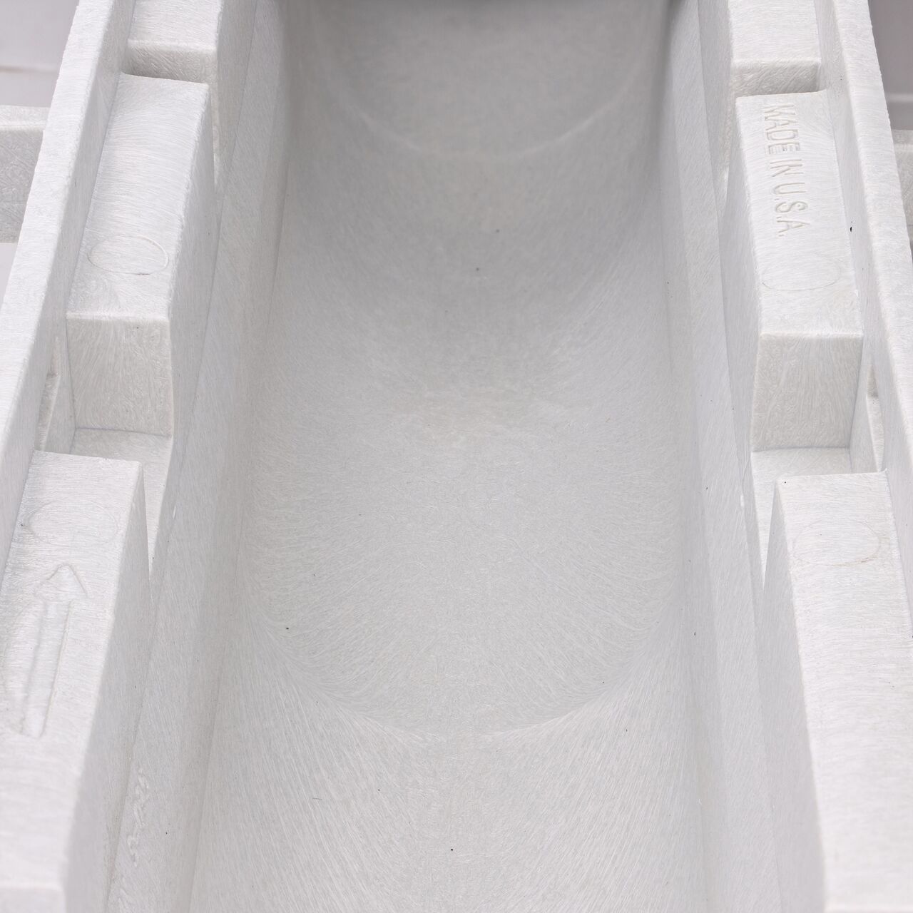 Closeup view of the grooved interior on the NDS Dura Slope Channel Drain, which supports and secures grates with the grate locking system (NDS DS-094N)