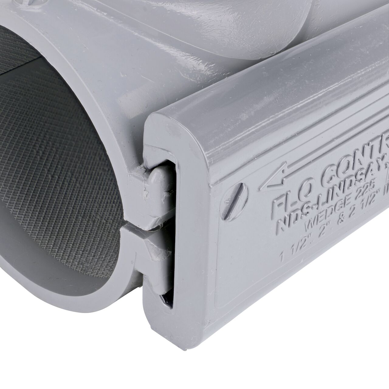 Closeup view of the wedge securely in the closed position on the 2-1/2 in. NDS Flo-Tap™ Rigid PVC saddle with 1-1/2 in. socket or 2 in. spigot (NDS 3225)