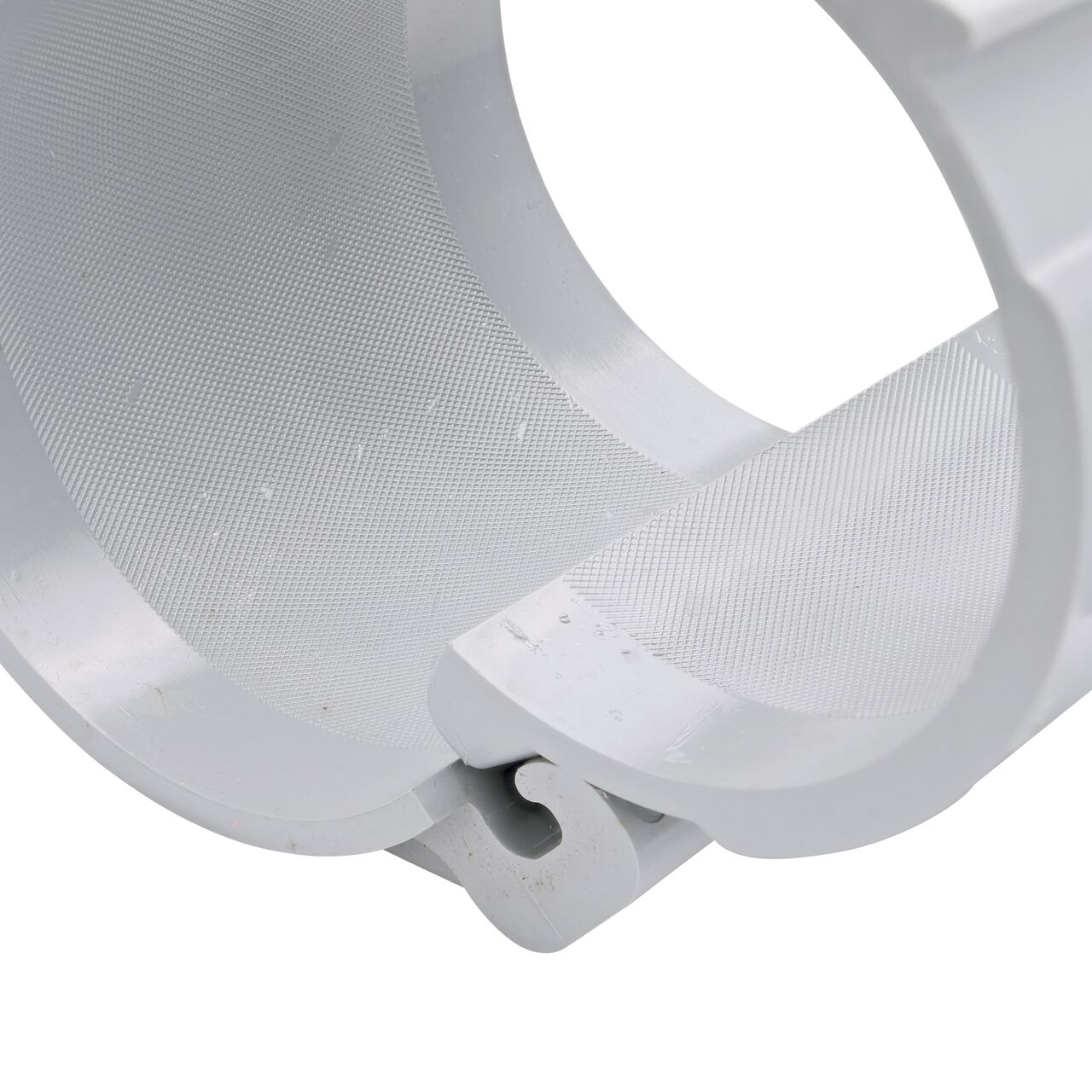 Closeup view of the hinge on the 4 in. NDS Flo-Tap™ Rigid PVC saddle with 3/4 in. socket or 1 in. spigot connection on top (NDS 3140) in the opened position that allows for easy installation onto Schedule 40 or Schedule 80 PVC pipe
