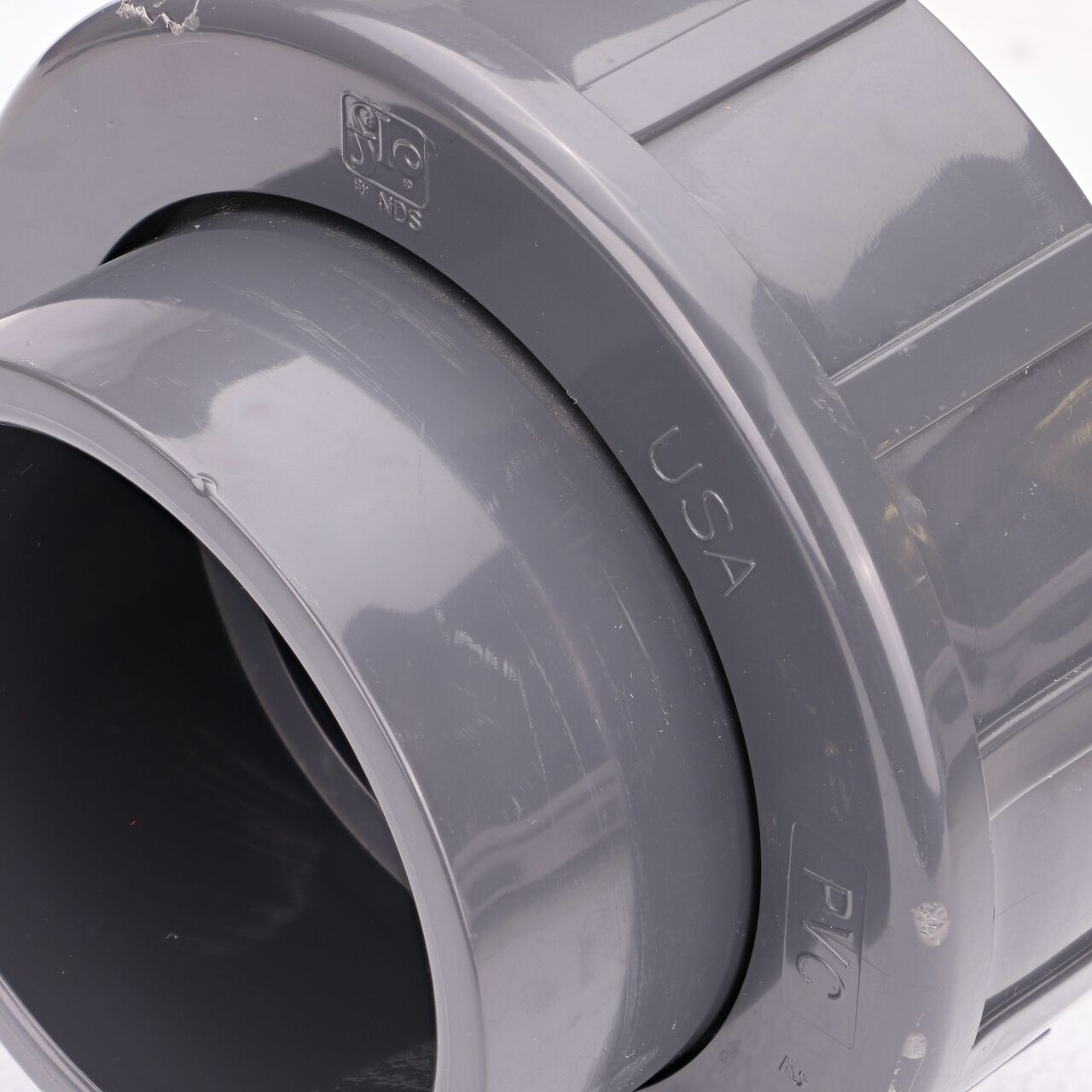 Close up view of the NDS 3 in. PVC Union showing NDS brand a leader in flow management solutions and the preferred choice of professionals since 1972 mark (NDS U-3000-S)