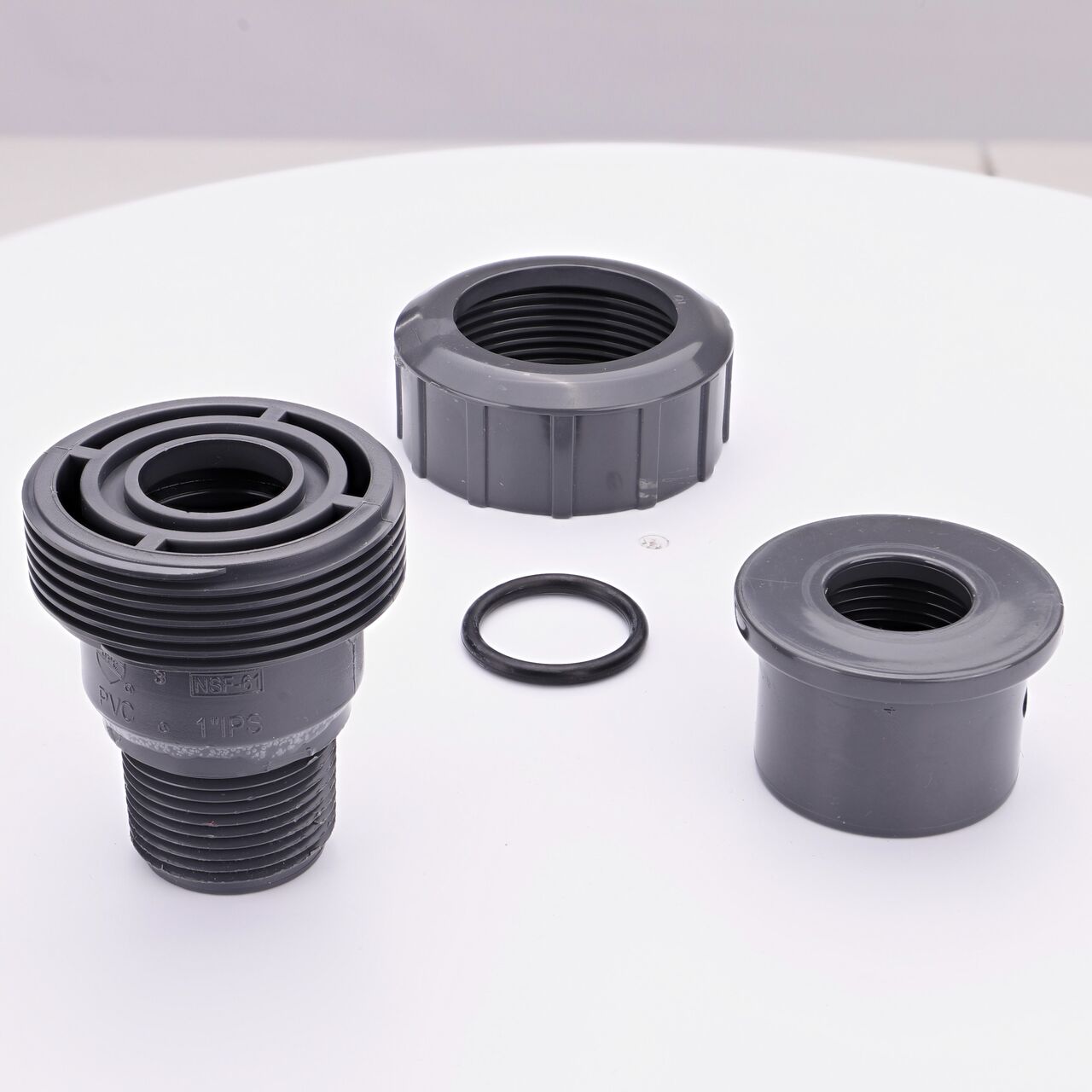 NDS PVC Union Ball Valve unassembled showing all the pieces including the female and male ends facing upwards that connect two 1 in. Sch. 80 pipes