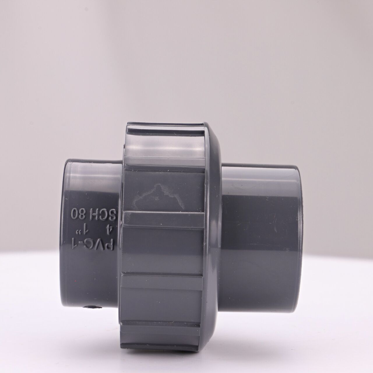 Side view of PVC Union, 1 in. Sch. 80 S X FPT showing two threaded ends that slide onto Sch. 80 pipe ends (NDS U-1000-ST)