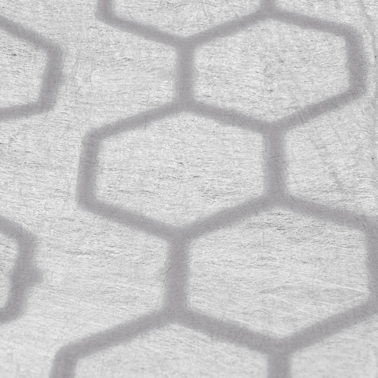 Closeup View of thermally welded, puncture-resistant geotextile fabric on the Black NDS EZ Roll® Gravel Pavers (NDS GP4X150G); fabric prevents gravel from migrating downward and lifting the paver, and is also porous to allow for filtration of stormwater runoff