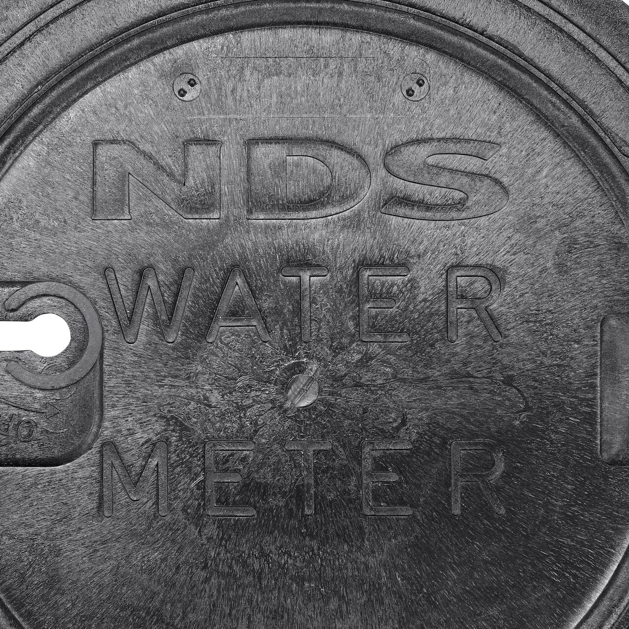 Closeup view of the water meter markings on the black water meter Drop-in cover for the NDS 16 in. Round Standard Series Meter Pit Boxes (NDS D2400-LOCSWBL)