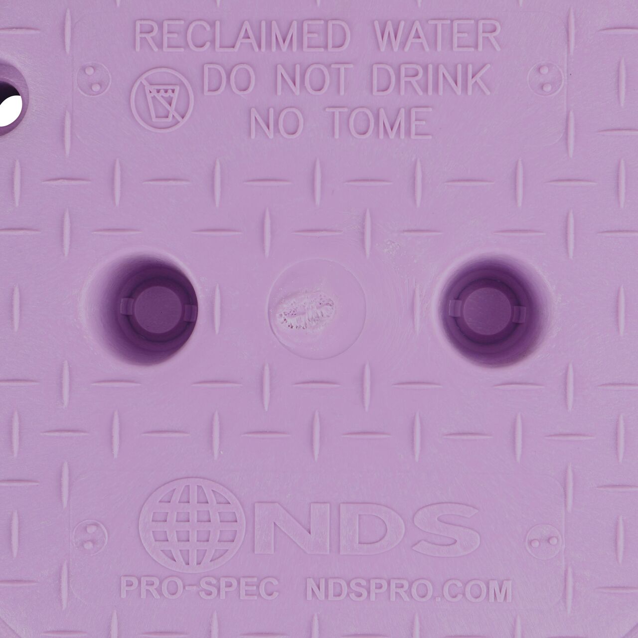 Closeup view of the Reclaimed Water markings on the purple reclaimed water valve box cover for the NDS 10 in. Round Pro-Spec® Standard Series Valve Box (NDS 312PBCR)