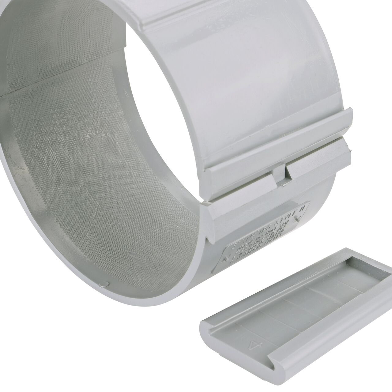 Closeup of the wedge latch uninstalled on the NDS Clamp-It™ Rigid PVC Saddle with 1-1/2 in. slip connection on top (NDS 458015) for 8 in. PVC pipe