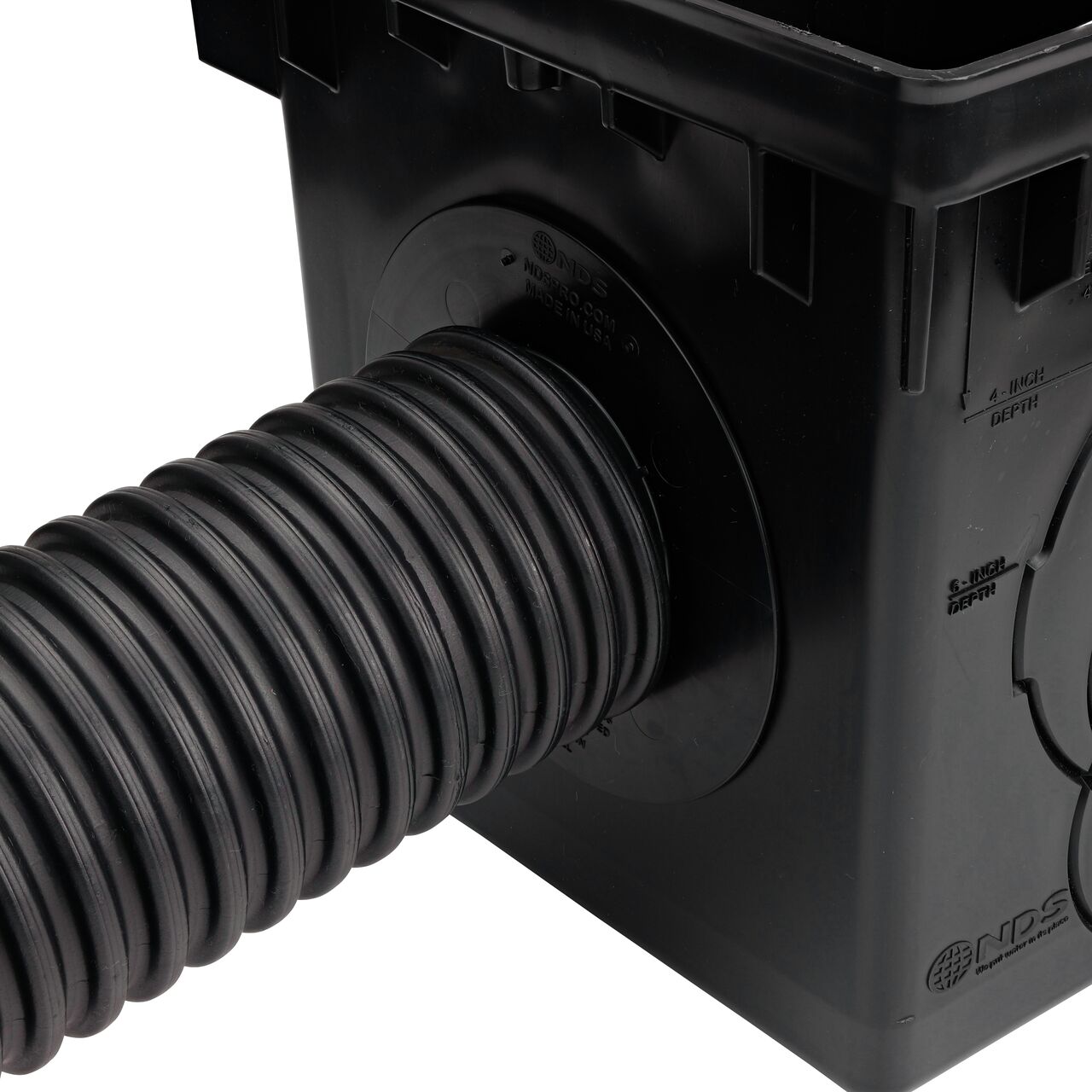 Connect 4 in. corrugated pipe over the locking tab outlet adapter (NDS 1243) on the 12 in. Catch Basin Drain (NDS 1200)