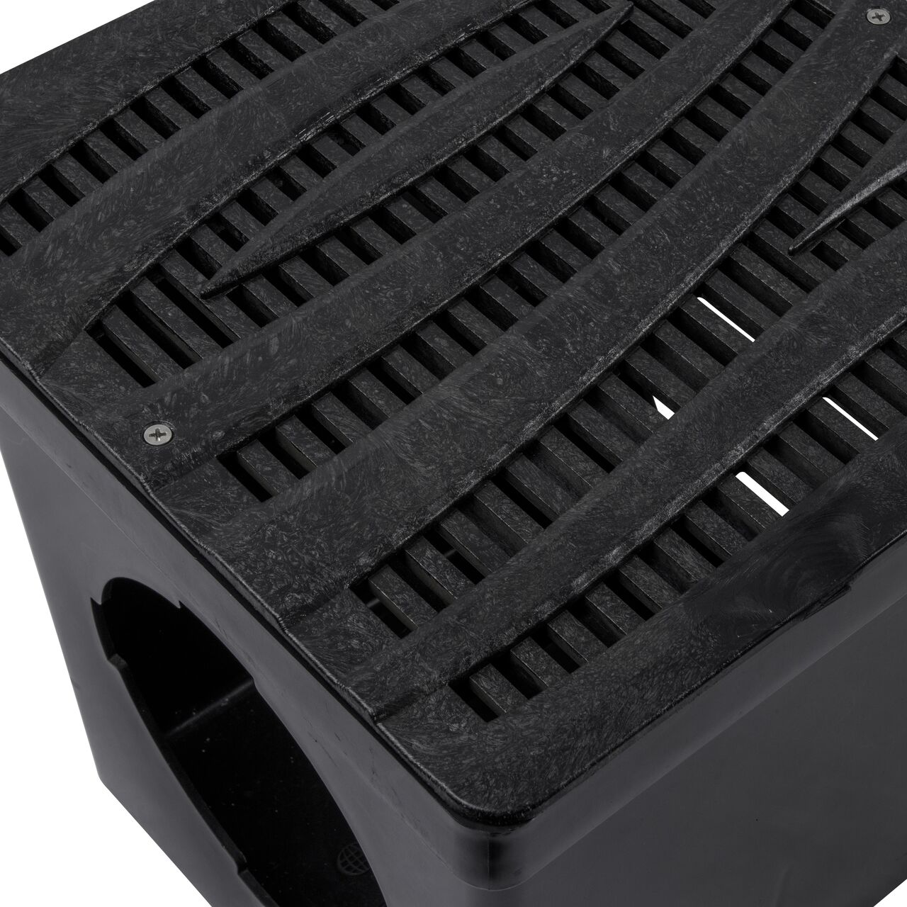 Closeup shot of NDS 12 in. Square Catch Basin Drain Grate, Decorative Wave Design, Black Plastic (NDS 1224) and how it fits securely within a 12 in. Square Catch Basin Drain with 2 Openings (NDS 1200*); retail