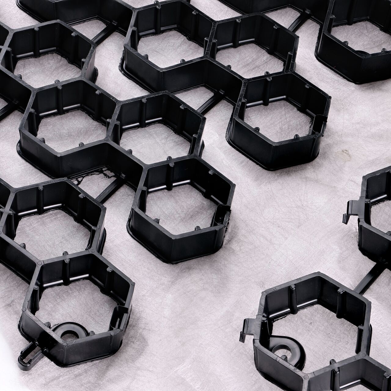 Align two sides of two NDS EZ Roll Gravel Paver rolls (NDS GP4X150) with the  top-down locking tabs tongue and groove sides next to one another