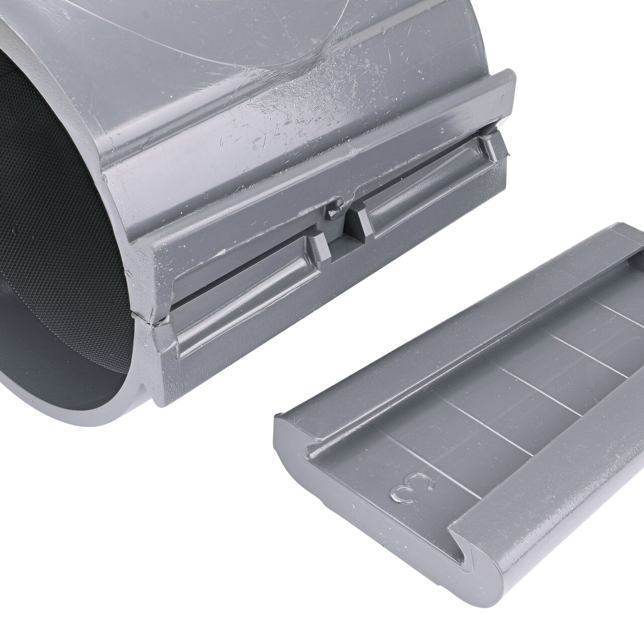 Closeup of the wedge latch uninstalled on the NDS Clamp-It™ Rigid PVC Saddle with 3/4 in. FPT connection on top (NDS 444007) for 4 in. PVC pipe