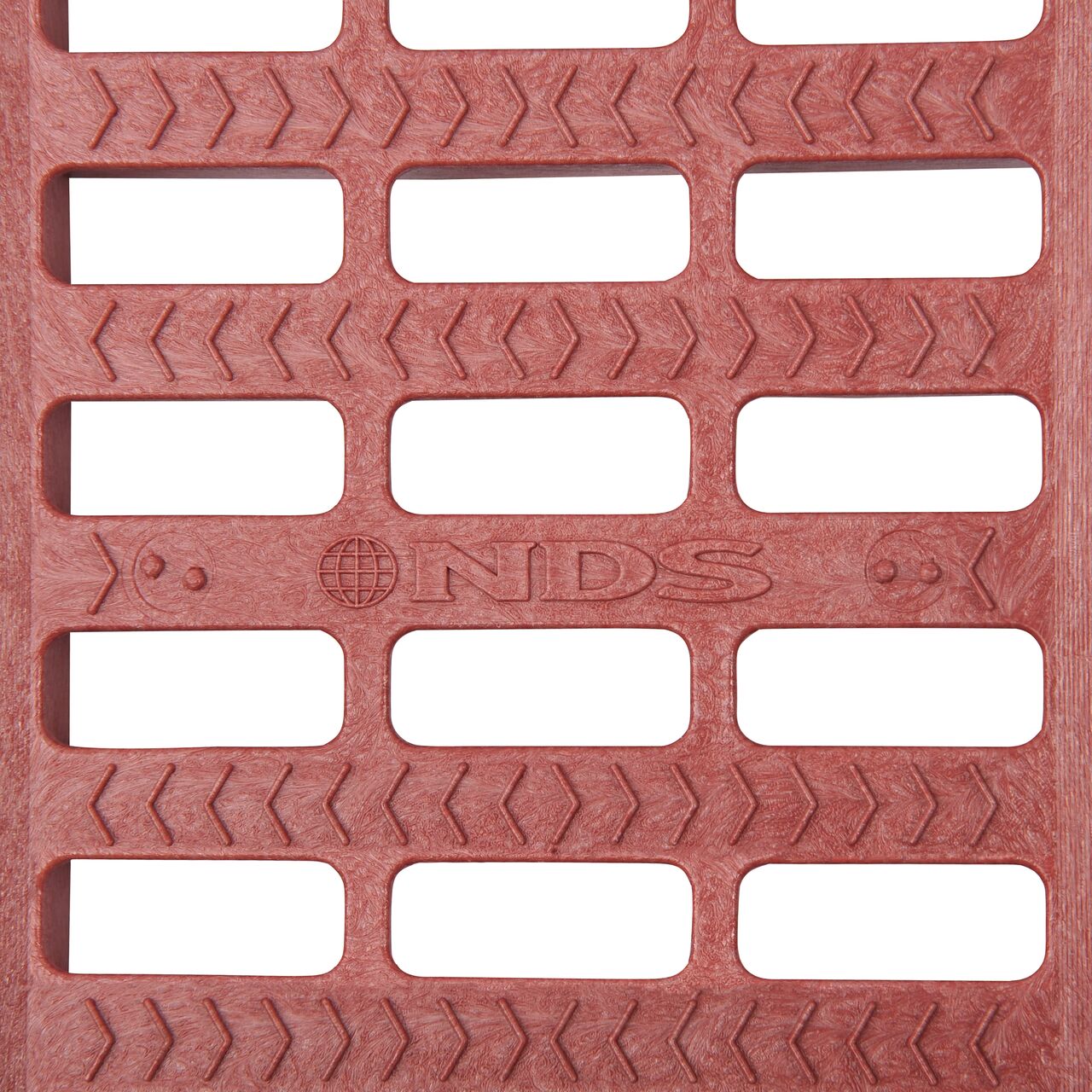 Top down partial closeup of grate openings on NDS 5 in. Pro Series Channel Drain Grate in Brick Red Plastic (NDS 818)