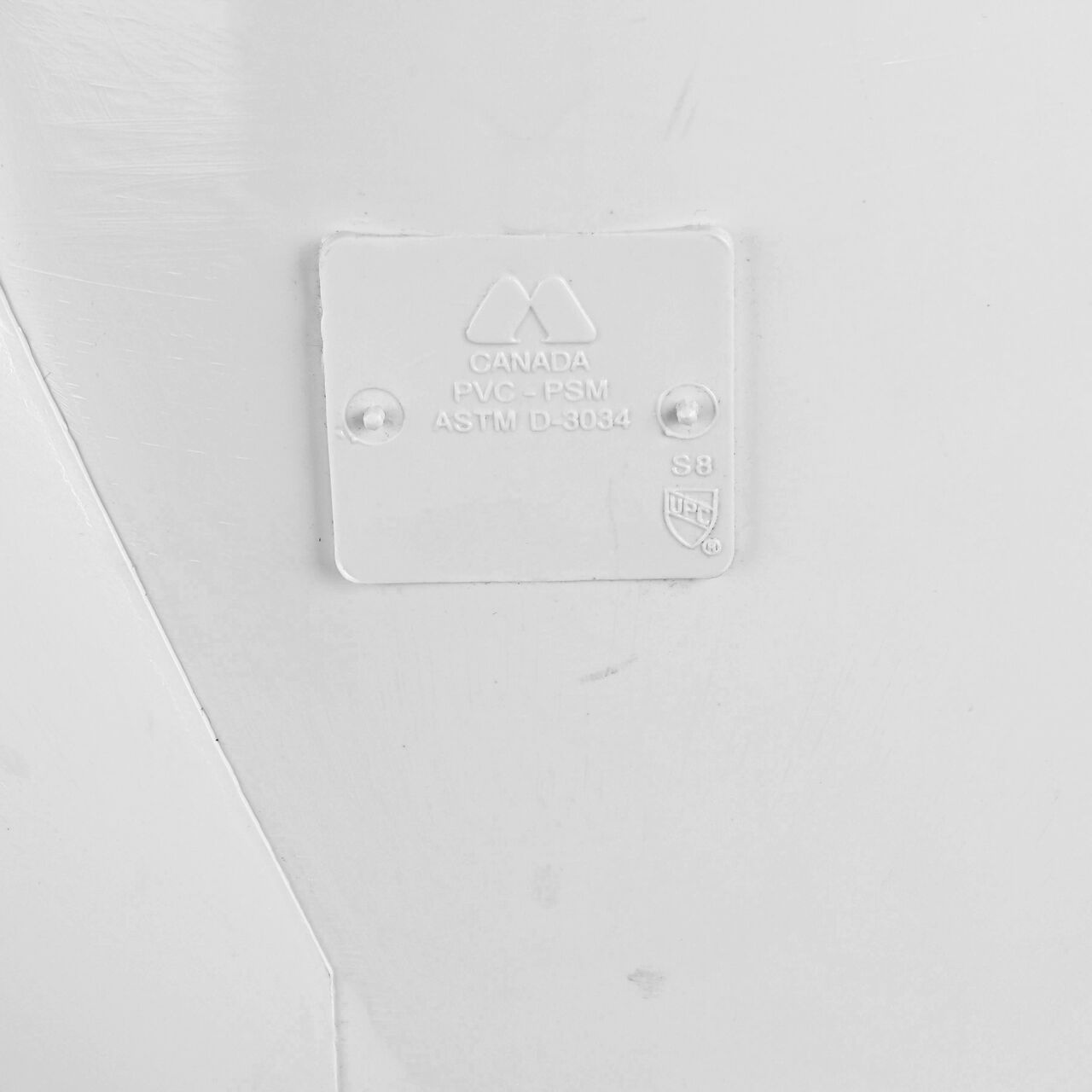 Closeup of the logo in the PVC 45 degree wye for 8 in. Sewer and Drain pipes, with 8 in. Hub X Hub X Hub connection (NDS 8P08)