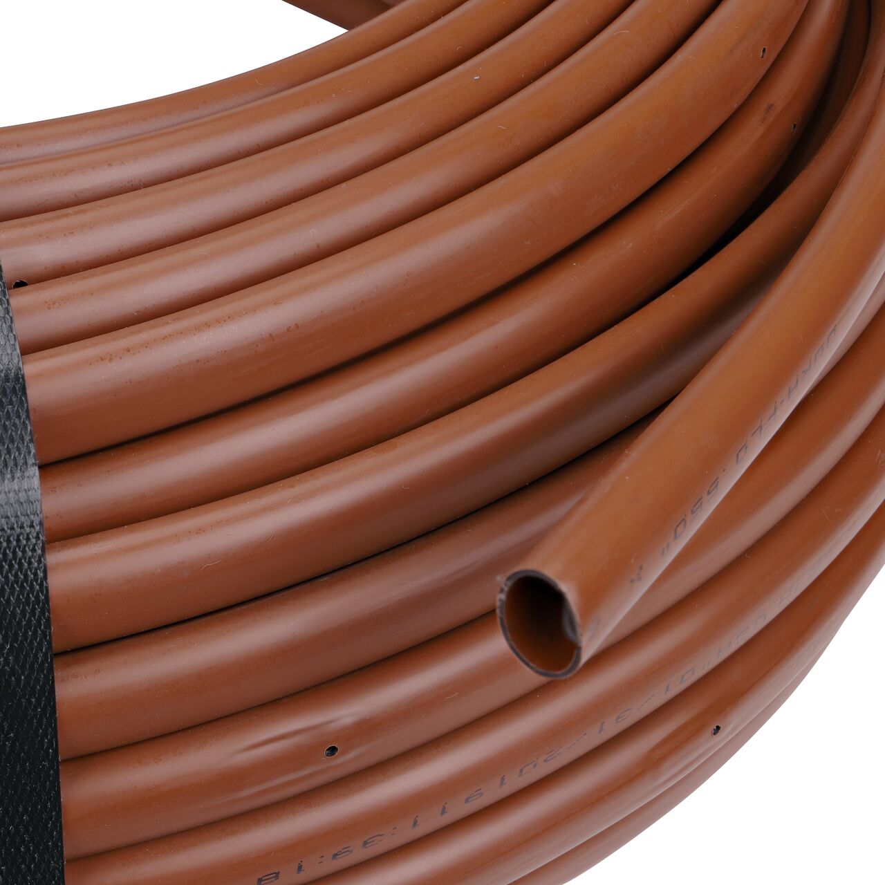 Closeup of the end of the NDS Black Tubing with 1.0 GPH Pressure Compensating Emitters iwth 12 in. Spacing to show how to pull out the dripline (NDS SFPC-BR-6212-025, NDS SFPC-BR-6412-025, NDS SFPC-BR-6418-025)