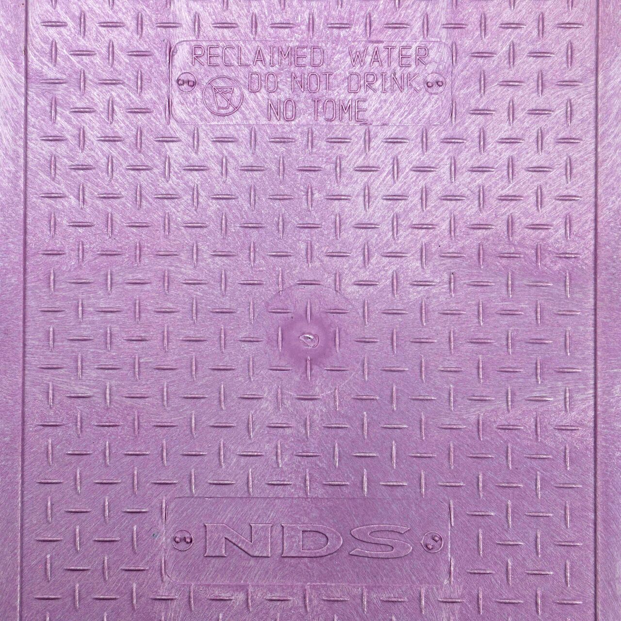 Closeup view of the Reclaimed Water markings on the Purple Reclaimed Water cover for the NDS 14 in. X 19 in. Rectangular Pro-Spec® Series Valve Box (NDS 313BCBR)