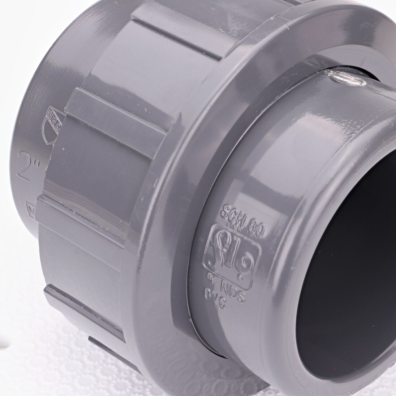 Close up view of the NDS 2 in. PVC Union showing NDS brand a leader in flow management solutions and the preferred choice of professionals since 1972 mark (NDS U-2000-S)