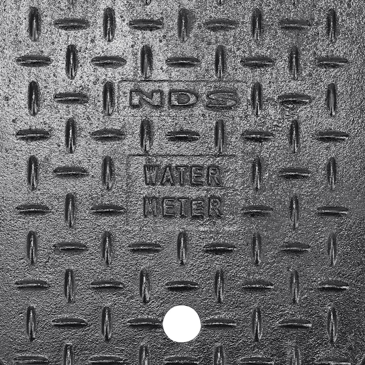 Closeup view of the Water Meter markings and Cast Iron reader door on the Black Cast Iron Water Meter Overlapping cover for the NDS 14 in. X 19 in. Rectangular Standard Series Meter Cover (NDS D1200-CIL)