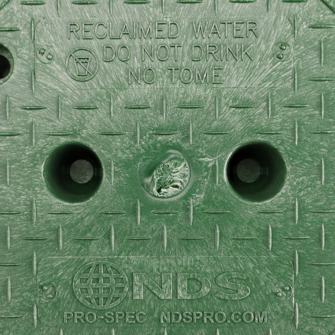 Closeup view of the Reclaimed Water markings on the Green cover for the NDS 10 in. Round Pro-Spec® Series Valve Box (NDS 311C)