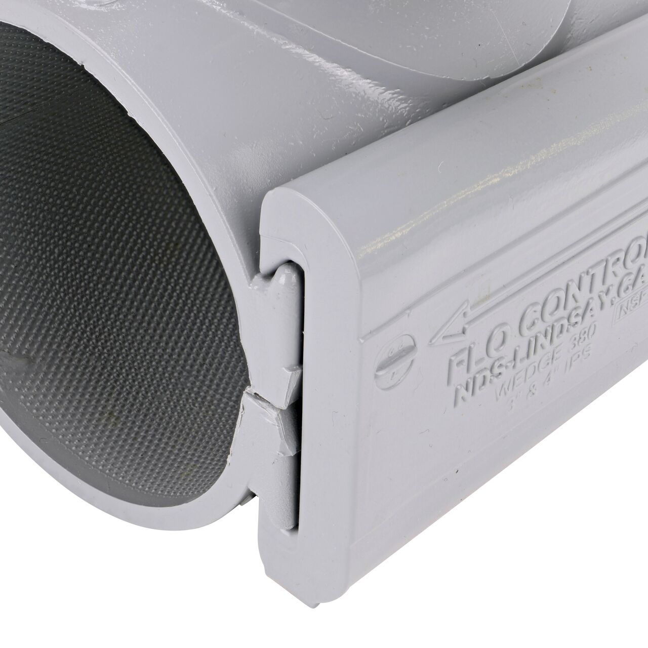 Closeup view of the wedge securely in the closed position on the 3 in. NDS Flo-Tap™ Rigid PVC saddle with 1-1/2 in. socket or 2 in. spigot (NDS 3230)