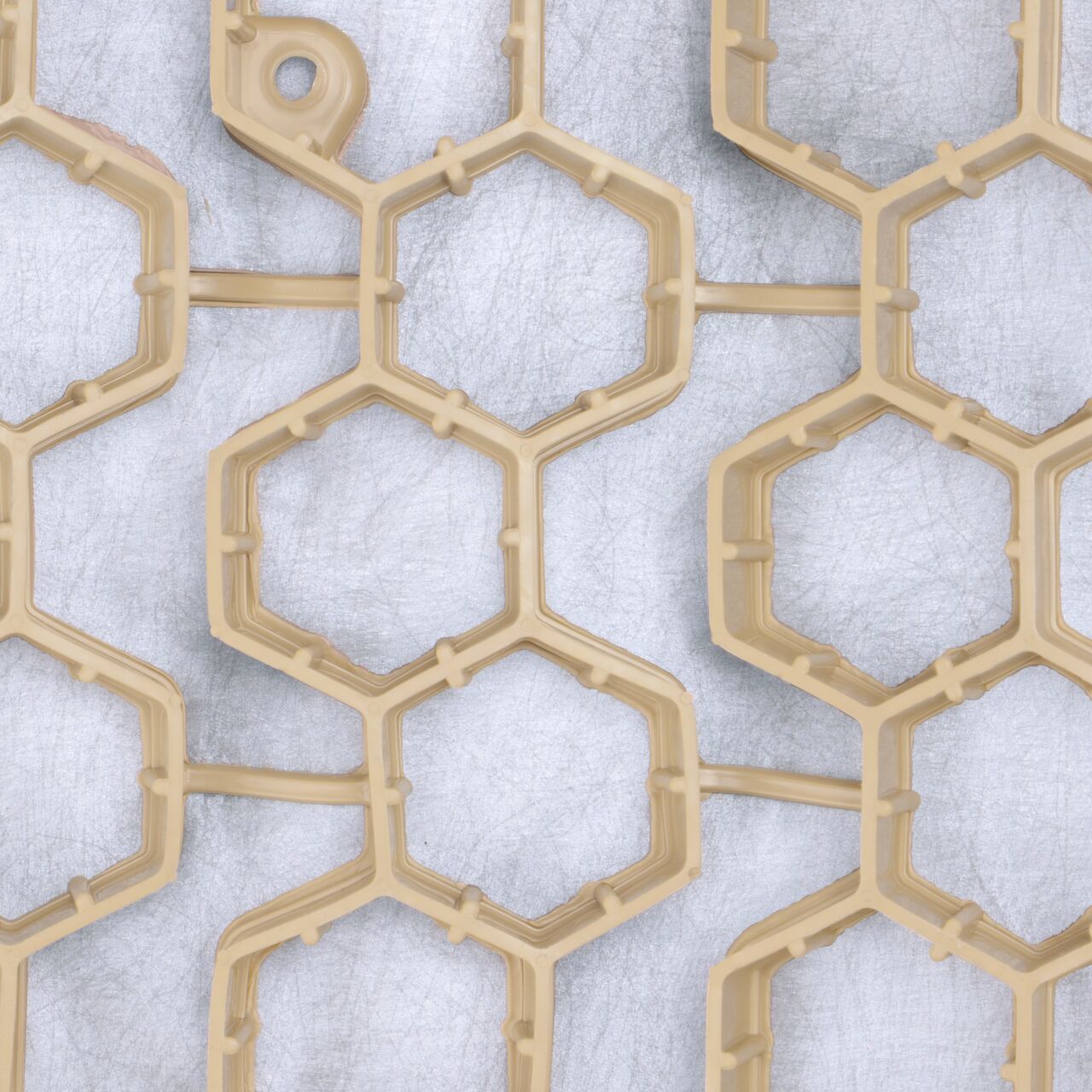 Top Down View of the Tan NDS EZ Roll® Gravel Paver (NDS GP4X150T) panels which are engineered using a web of hexagonal cells with shared walls and thermally welded geotextile fabric