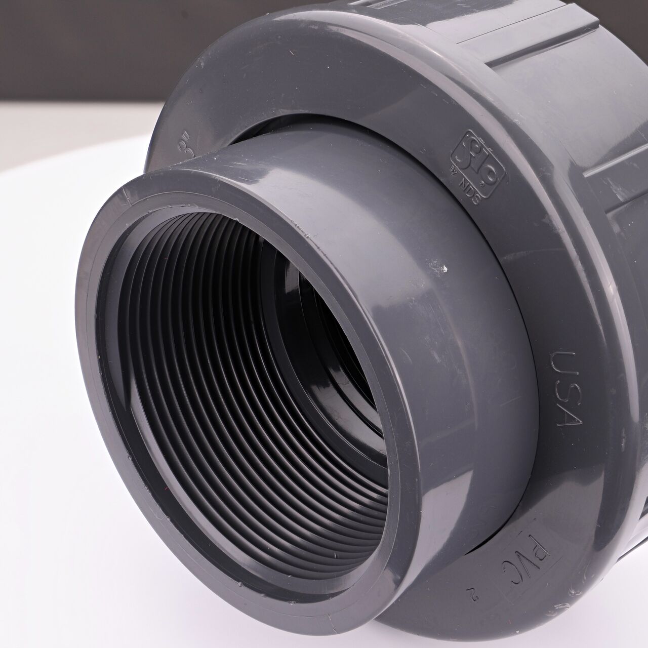 Closeup view of the other threaded end on the NDS 3 in. PVC Union (NDS U-3000-T) used to connect pipes and provide a quick way to separate pipes when needed