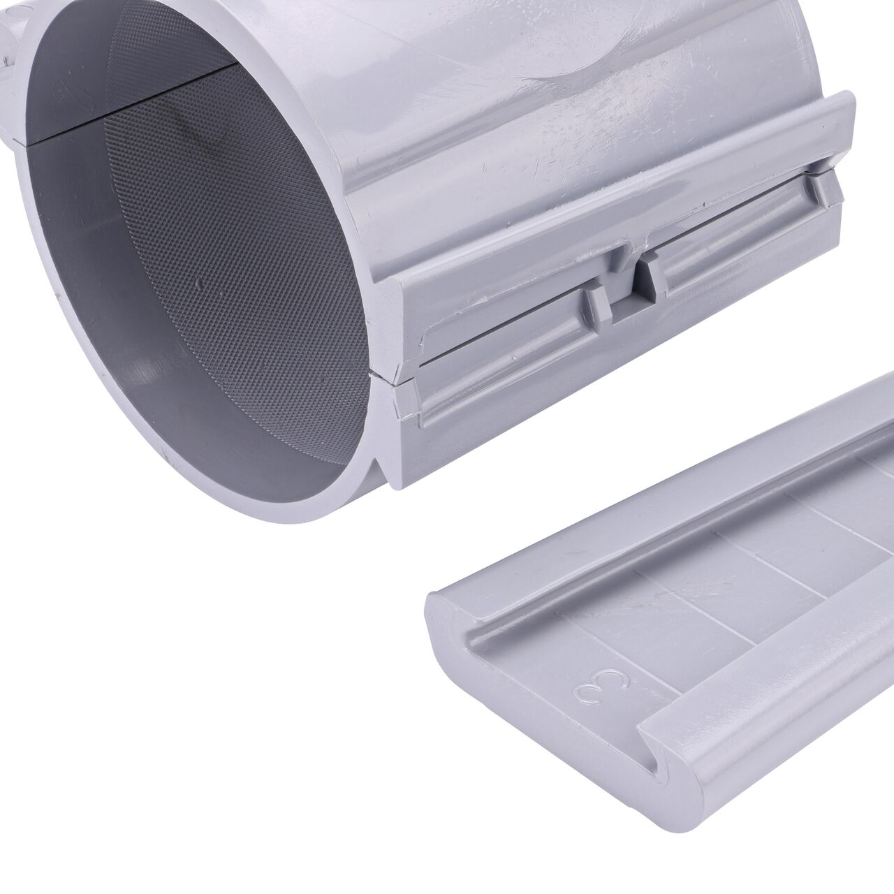 Closeup of the wedge latch uninstalled on the NDS Clamp-It™ Rigid PVC Saddle with 1 in. FPT connection on top (NDS 444010) for 4 in. PVC pipe