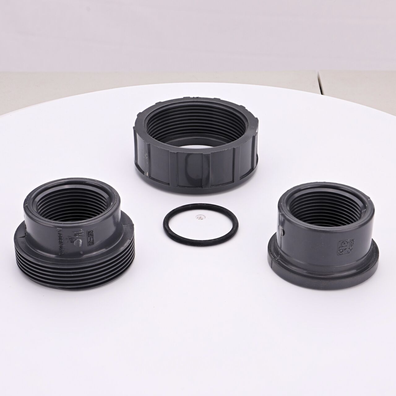 The NDS 1-1/4 in. FPT PVC Union shown here unassembled, includes the EPDM O-ring that is placed in the center of the union to create a leak-resistant seal (NDS U-1250-T)