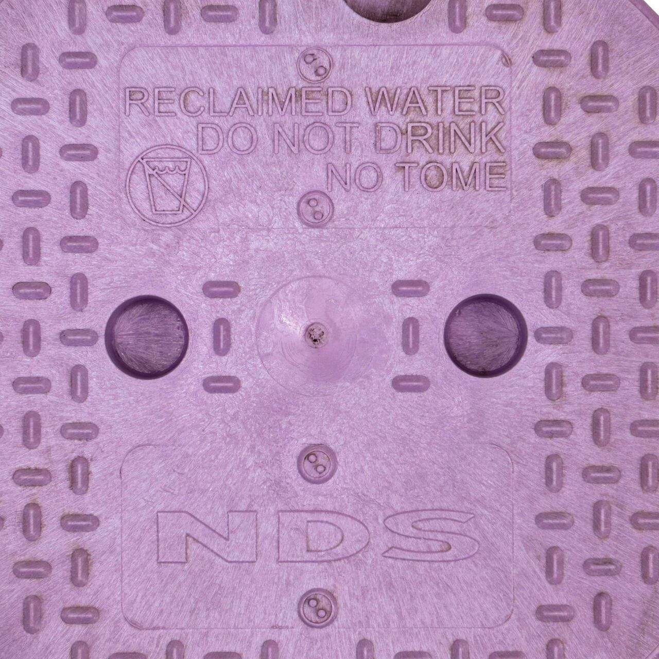 Closeup view of the reclaimed water markings on the purple cover for the NDS 10 in. Round Standard Series Valve Box (NDS 111CR)