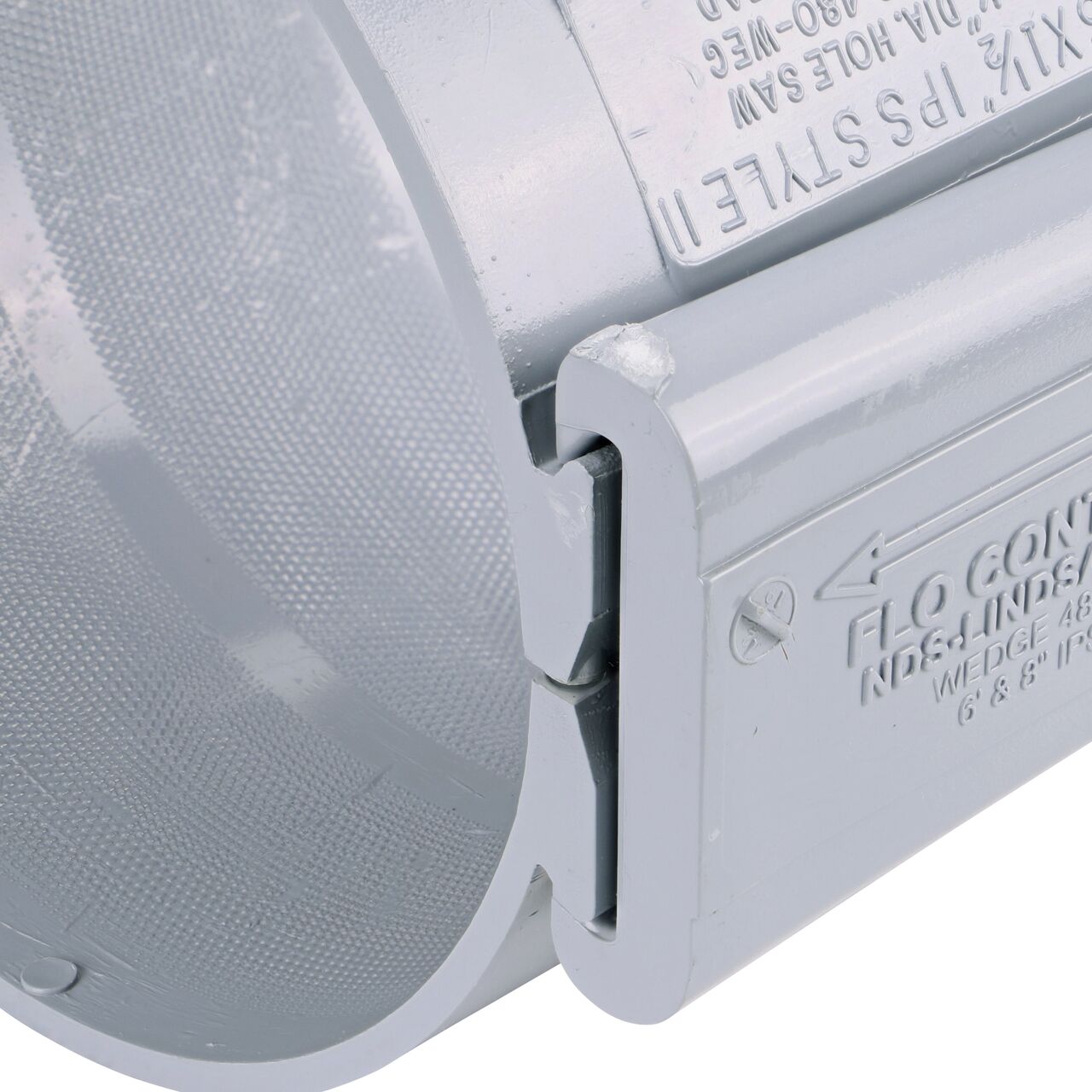 Closeup of the wedge installed securely on the NDS Clamp-It™ Rigid PVC Saddle with 1-1/2 in. FPT connection on top (NDS 446015) for 6 in. PVC pipe