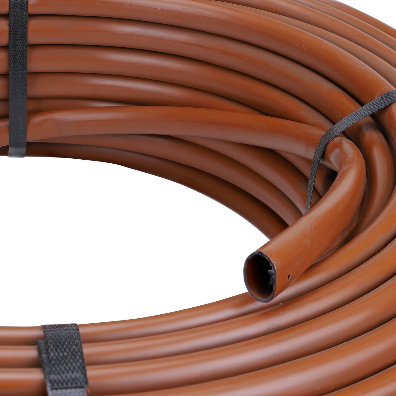 Closeup of the diameter of the NDS Black Tubing with 1.0 GPH Pressure Compensating Emitters iwth 12 in. Spacing (NDS SFPC-BR-6212-025, NDS SFPC-BR-6412-025, NDS SFPC-BR-6418-025)