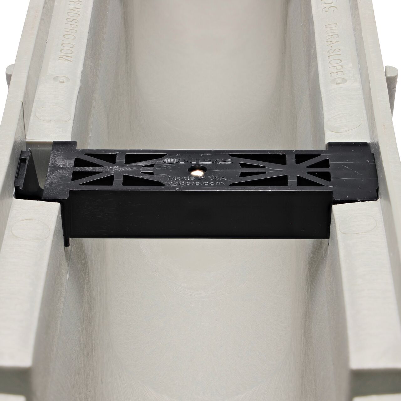 Closeup view of the grate locking system on the NDS Dura Slope Channel Drain, which locks grate to the integral frame (NDS DS-101N)