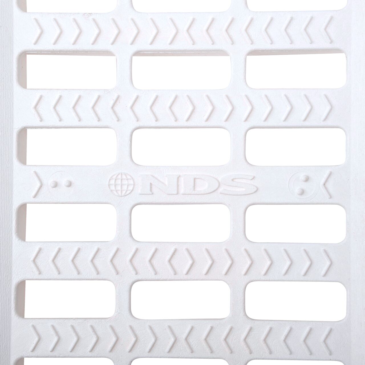 Top down partial closeup of grate openings on NDS 5 in. Pro Series Channel Drain Grate in White Plastic (NDS 819)