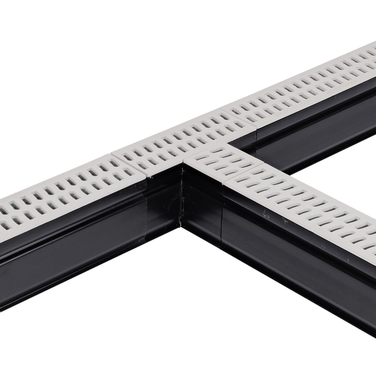 Installation shot with two channel drains and grates to the NDS Gray Slim Channel™ Drain Tee and Grate (NDS 9373)