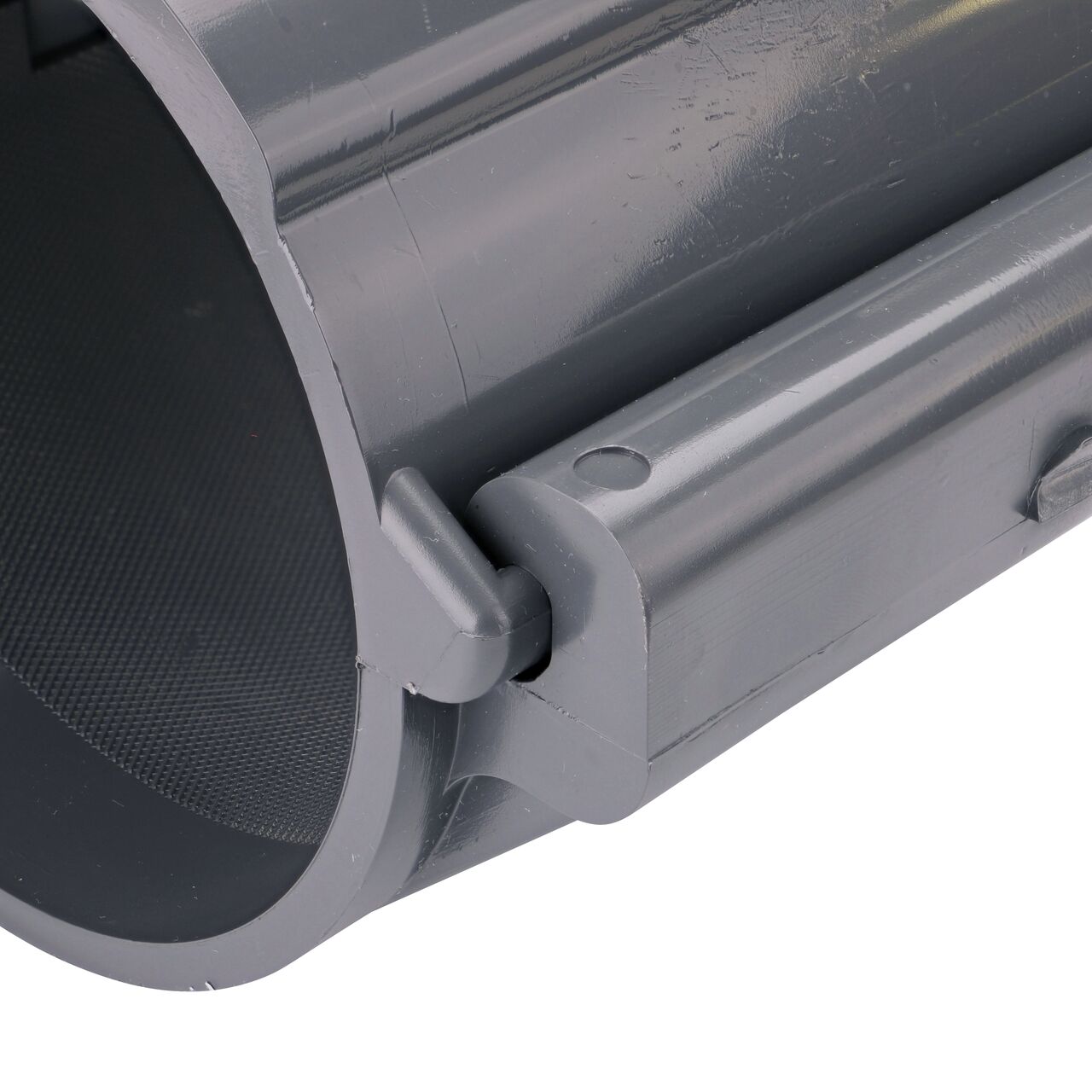 Closeup of the hinge closed on the NDS Clamp-It™ Rigid PVC Saddle with 2 in. FPT connection on top (NDS 444020) for 4 in. PVC pipe