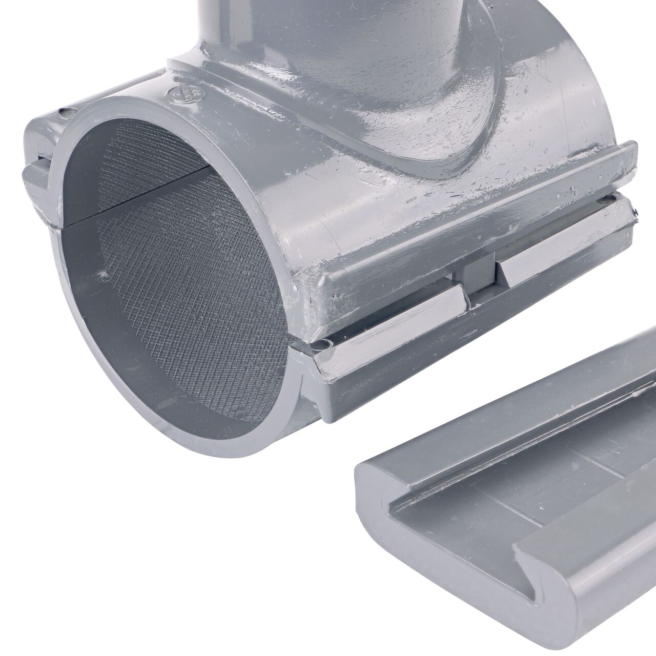 Closeup of the wedge latch uninstalled on the NDS Clamp-It™ Rigid PVC Saddle with 1-1/2 in. slip connection on top (NDS 432515) for 2-1/2 in. PVC pipe