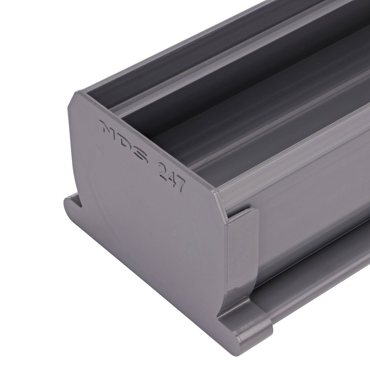 Closeup of the NDS Spee-D® Channel Drain End Cap (NDS 247) connected to a Spee-D® Channel Drain (NDS 400, NDS 400-10)