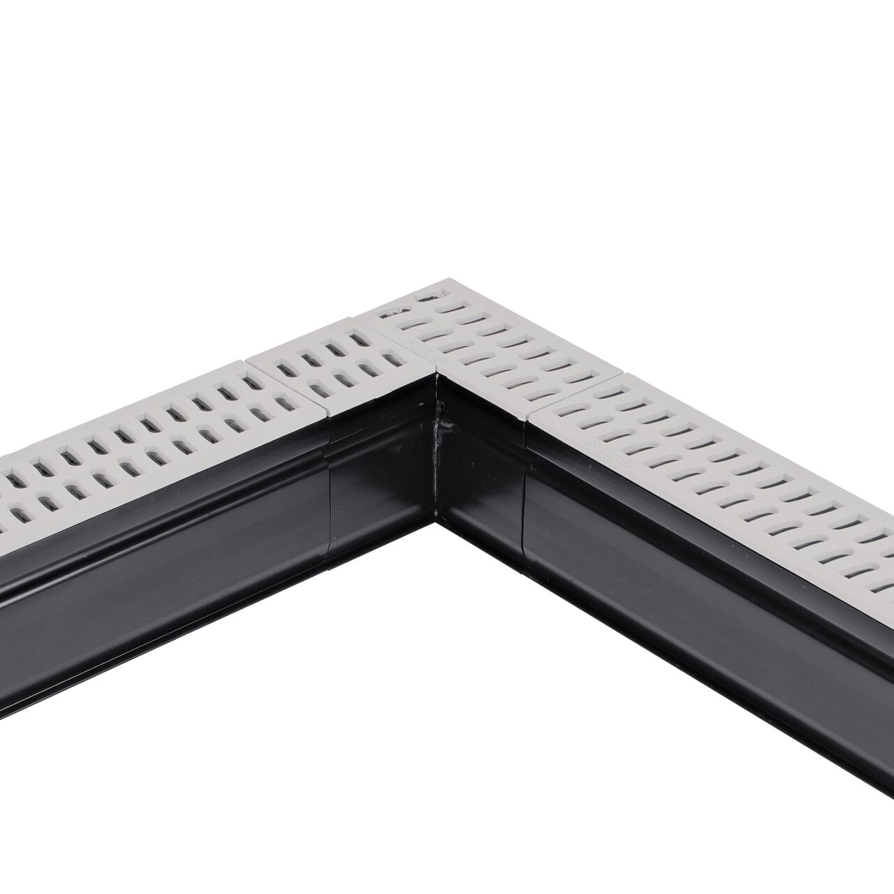 Installation shot with two channel drains and grates to the NDS Gray Slim Channel™ Drain 90° Elbow and Grate (NDS 9383)