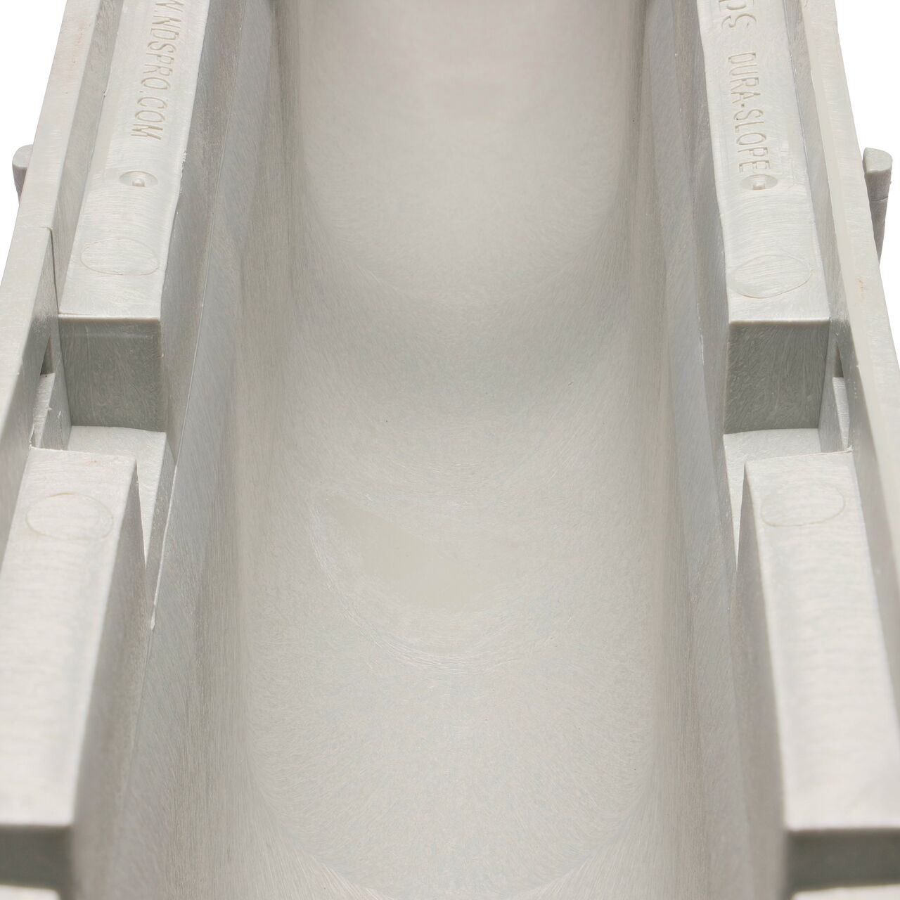 Closeup view of the grooved interior on the NDS Dura Slope Channel Drain, which supports and secures grates with the grate locking system (NDS DS-101N)