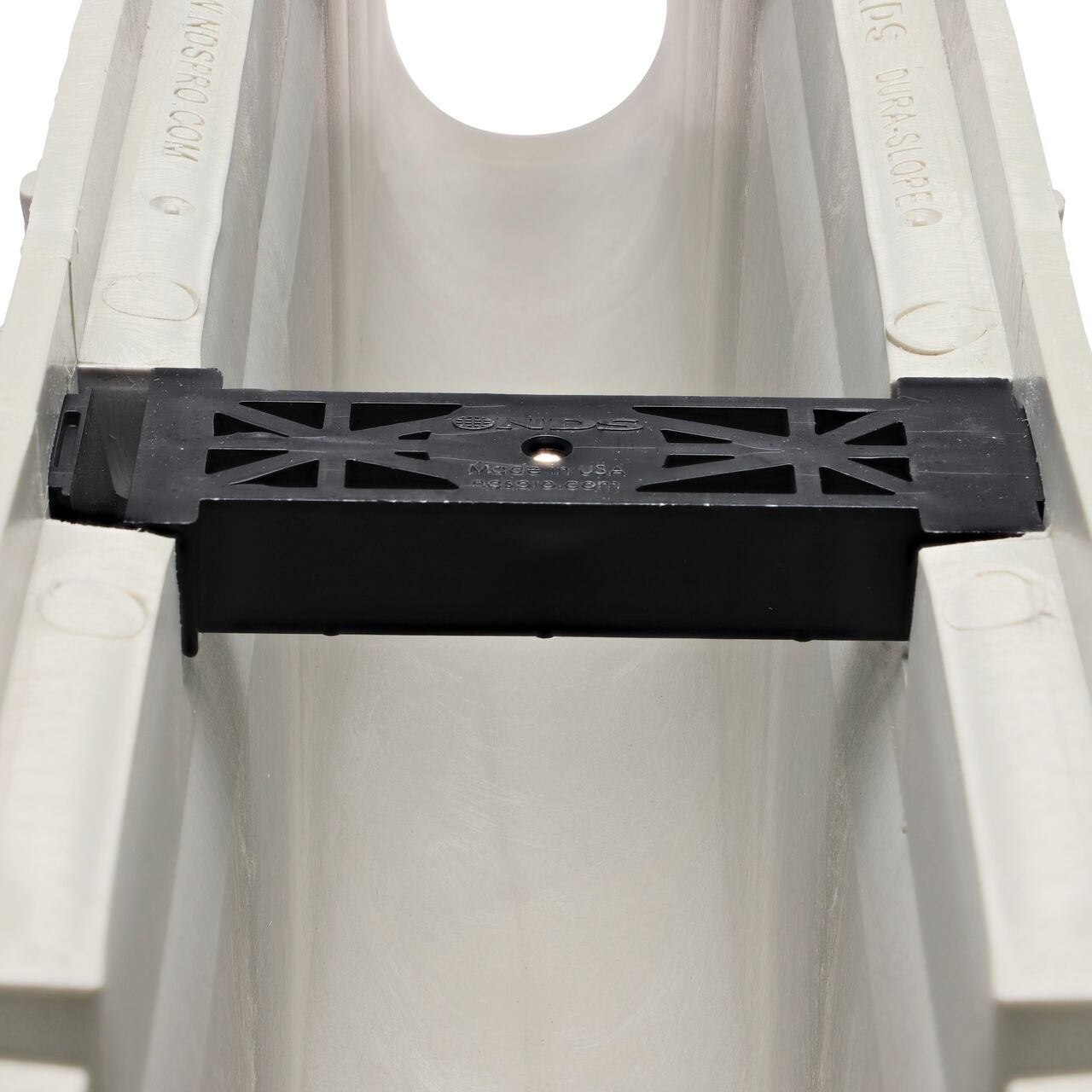 Closeup view of the grate locking system on the NDS Dura Slope Channel Drain, which locks grate to the integral frame (NDS DS-112N, NDS DS-113, NDS DS-114)