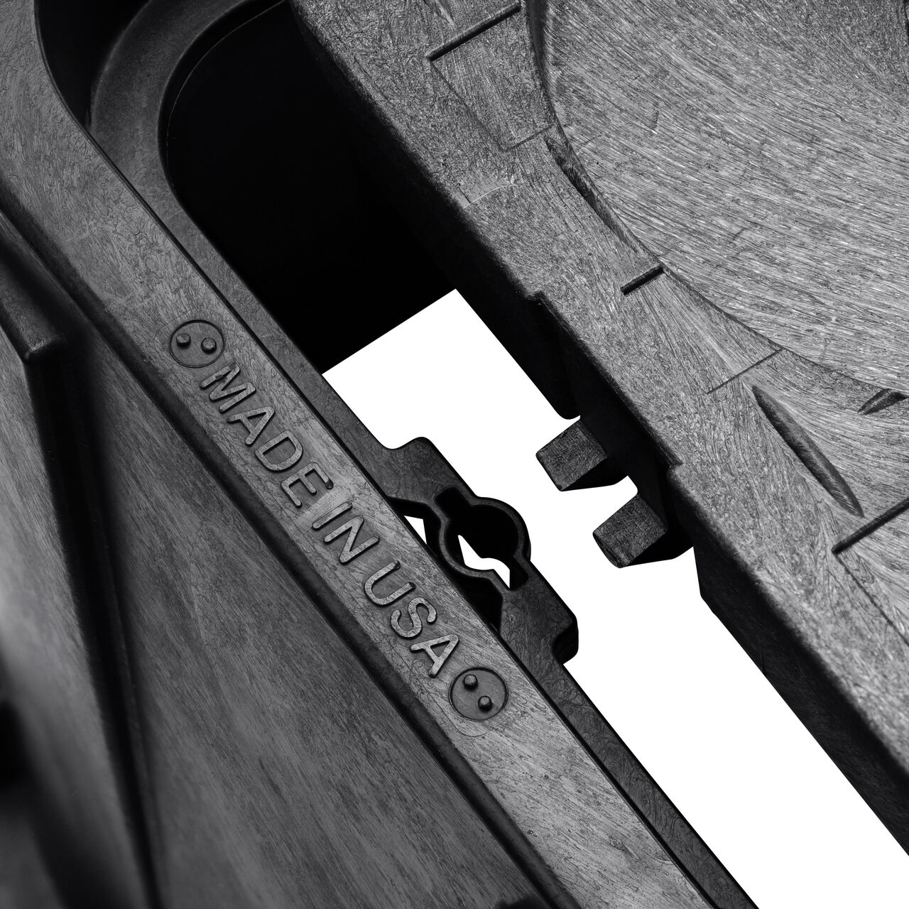 Closeup view of the pipe hole on the Black NDS 14 in. X 19 in. Rectangular Meter Box (NDS D12-TAMR) for water and irrigation pipe connections
