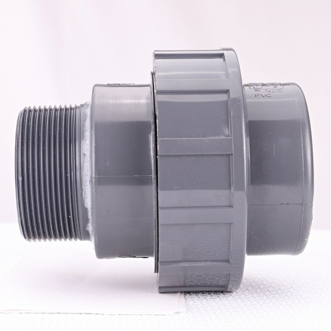 Side view of the NDS 2 in. PVC Union (NDS U-2000-SM) shows MPT and slip end that has a pull-apart feature to quickly disconnect from pipes (NDS U-2000-SM)